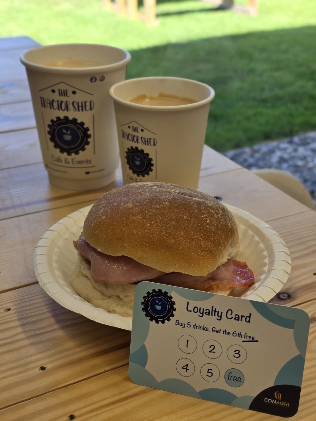 A fresh bacon roll with the Tractor Shed loyalty card