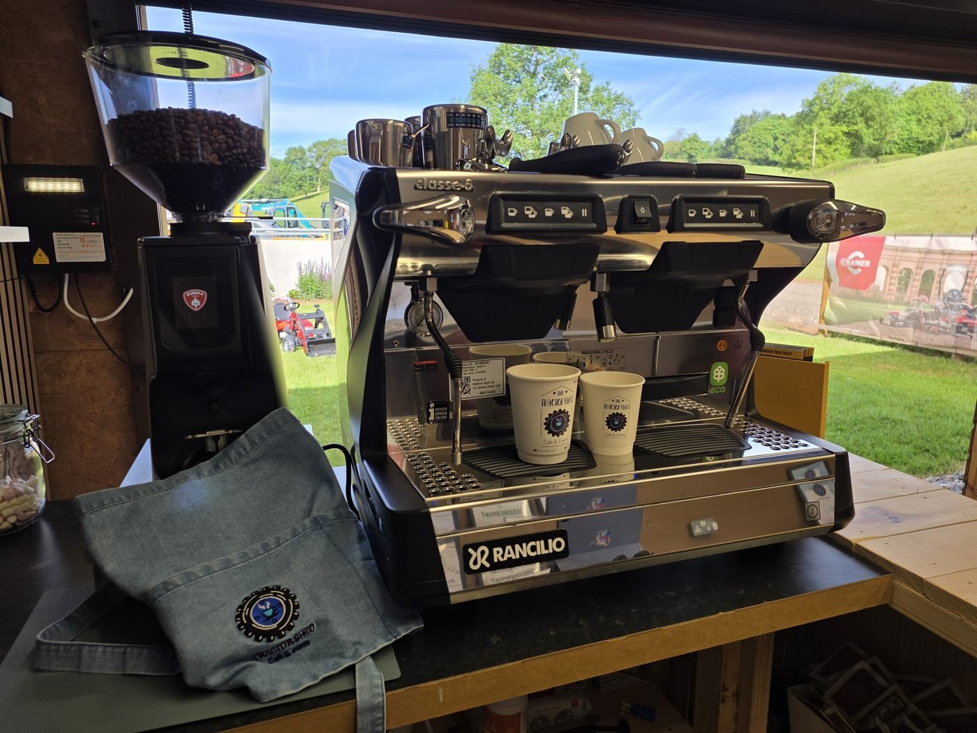 The Tractor Shed espresso machine with the Devon countryside behind
