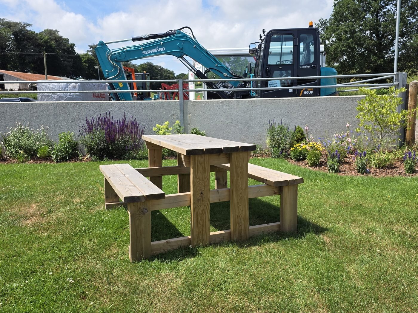 A picnic bench on the lawn in the Tractor Shed garden